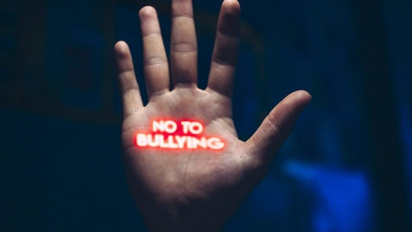 a hand with the word no to bullying written on it